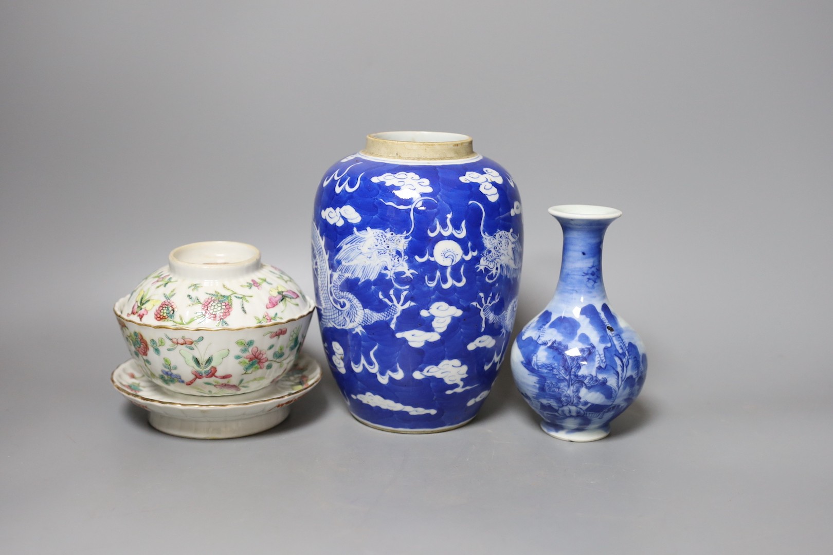 A 19th century Chinese famille rose rice bowl, cover and stand, together with a blue and white dragon jar and similar bottle vase. Largest 18cm